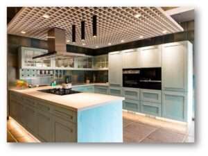 tylish modular kitchen with pastel blue cabinets, a spacious island, built-in appliances, and a decorative false ceiling with pendant lighting.