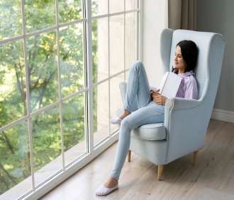 young-woman-holding-her-book-while-looking-out-window_23-2149029695 (1)