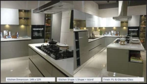 Luxury L-shaped modular kitchen with island counter, glossy glass finish cabinets, PU shutters, and premium storage solutions – Contact for Custom Kitchen and Wardrobes in Uttarakhand